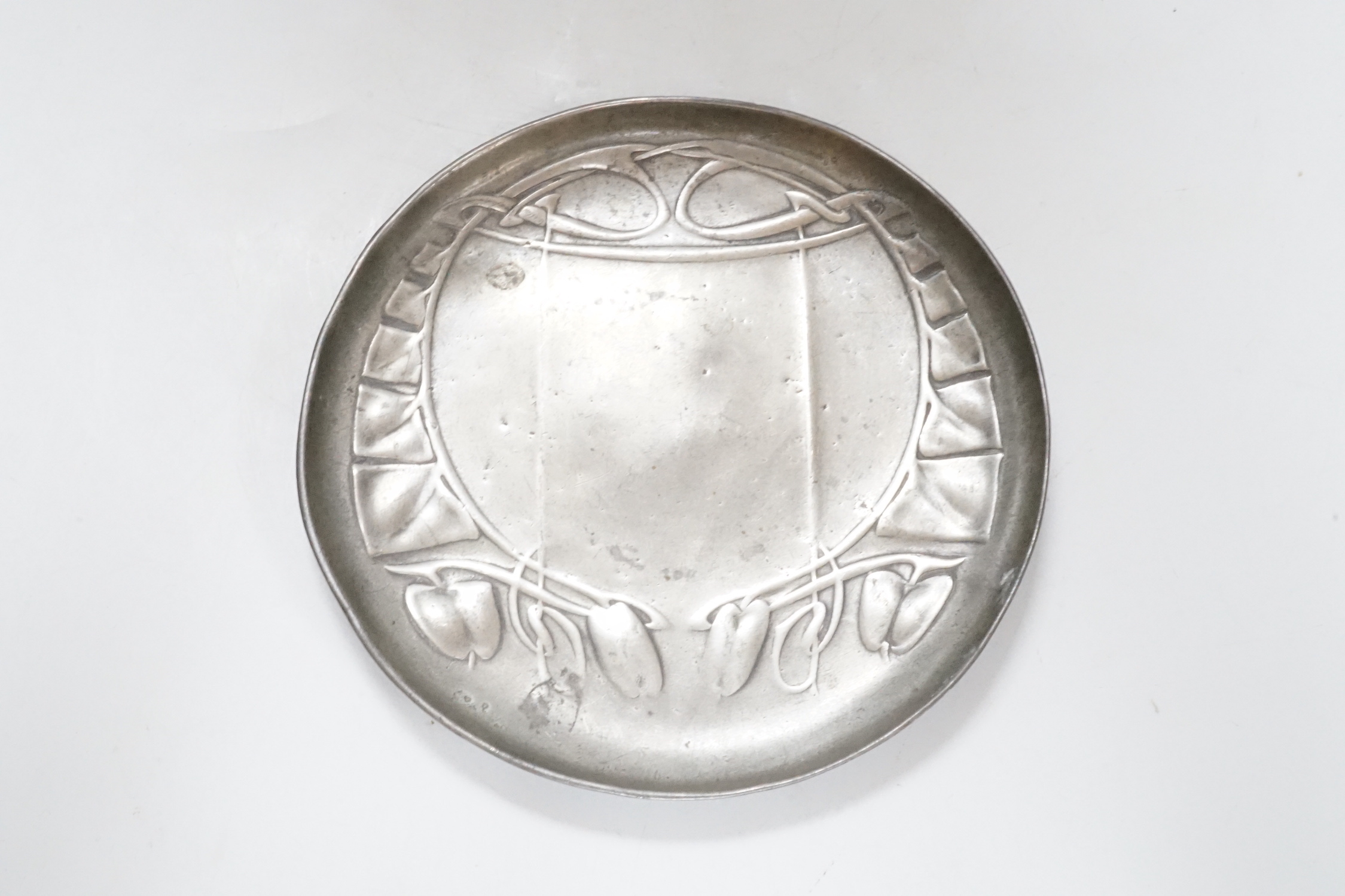 An Art Nouveau Liberty & Co pewter shallow circular dish, stamped on base and numbered 0231, 14cm diameter